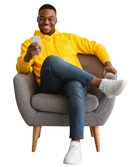 Man sitting in a chair using his online banking app on his mobile phone