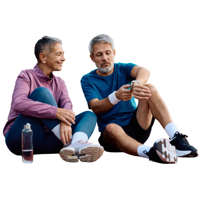 Active couple, post-workout, sitting down looking at a fitness watch.