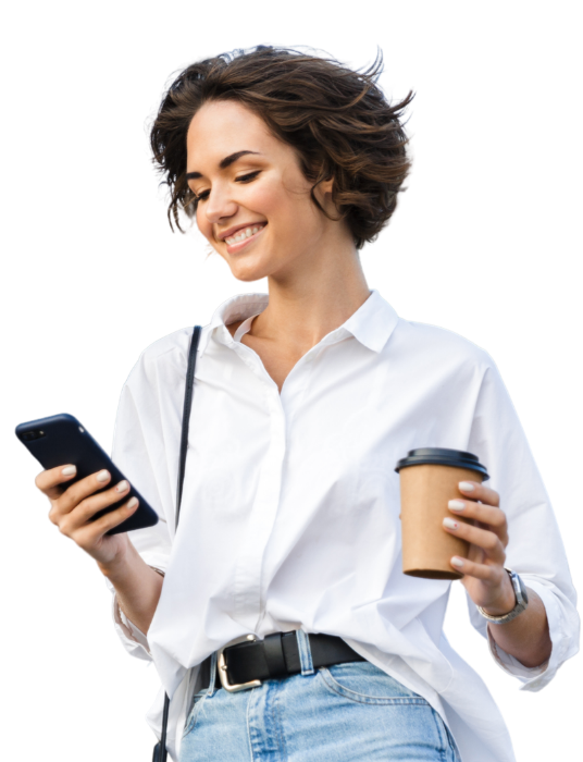 Woman on the go, holding a cup of coffee and a smart phone.