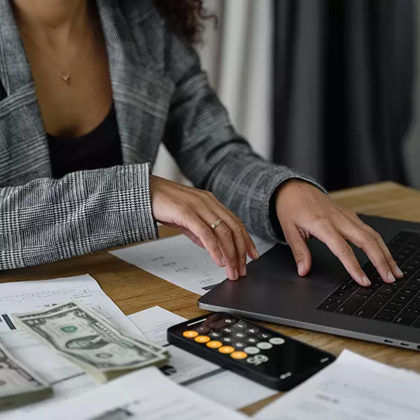 A woman views her digital safe on her laptop as she finalizes her estate planning and budget.