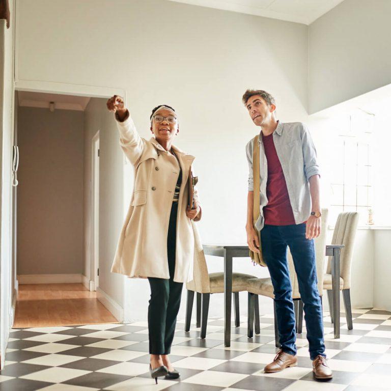 Man spots with realtor spots potential damage in home when house-hunting.