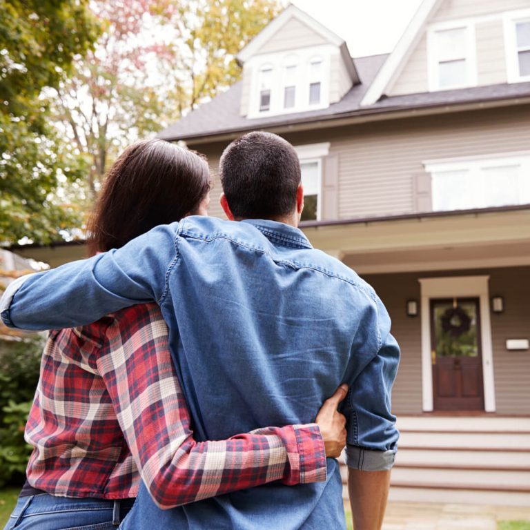 Man and woman looking at their new home.