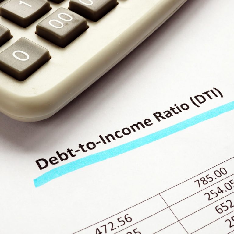 Close-up paperwork of debt to income ratio statement and calculator