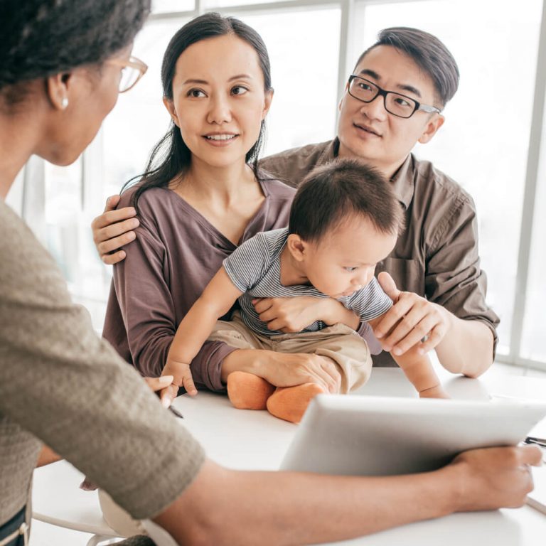 Young family sitting down with a financial advisor.