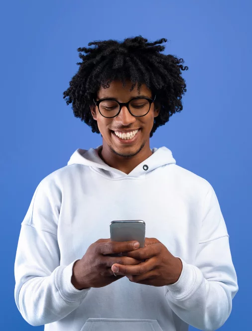 Young man checks his Quorum Mastercard balance online with his cell phone.