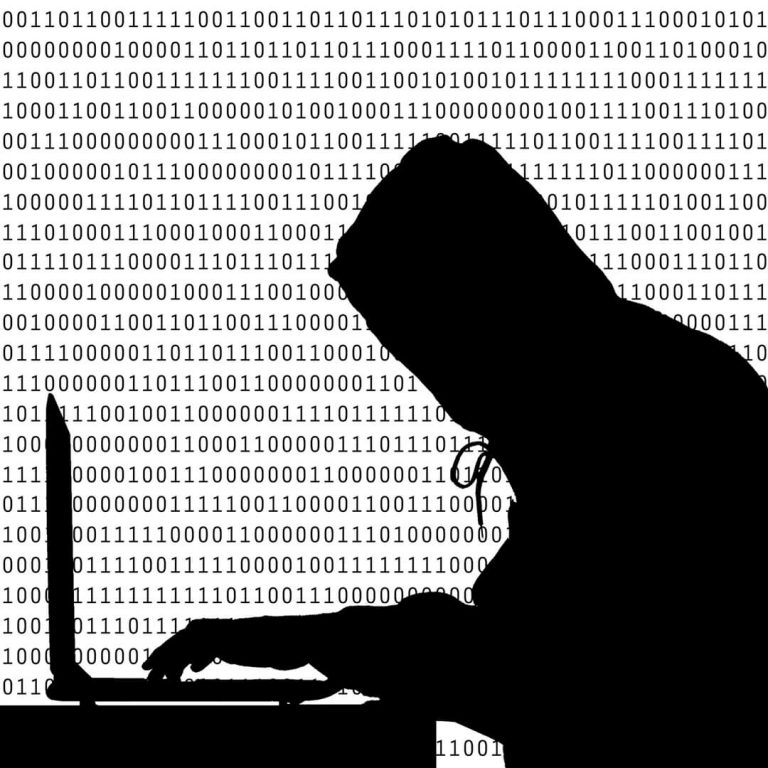 Silhouette of hacker at laptop with O's and 1's behind him.