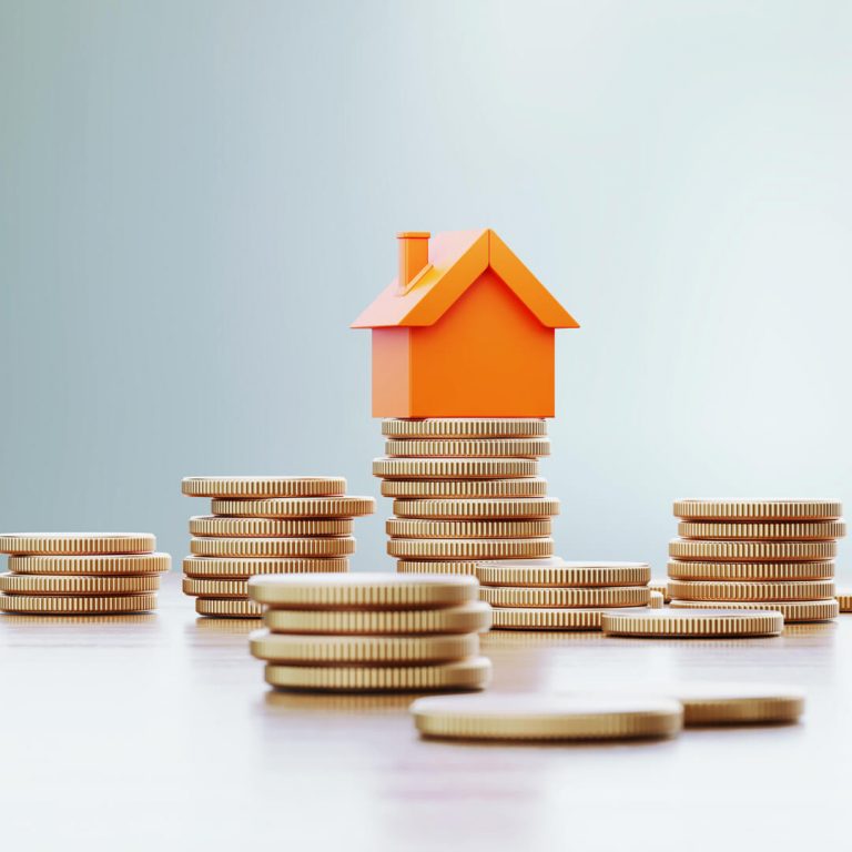 Orange toy house sitting over coin stacks, illustrating the concept of increasing home value.