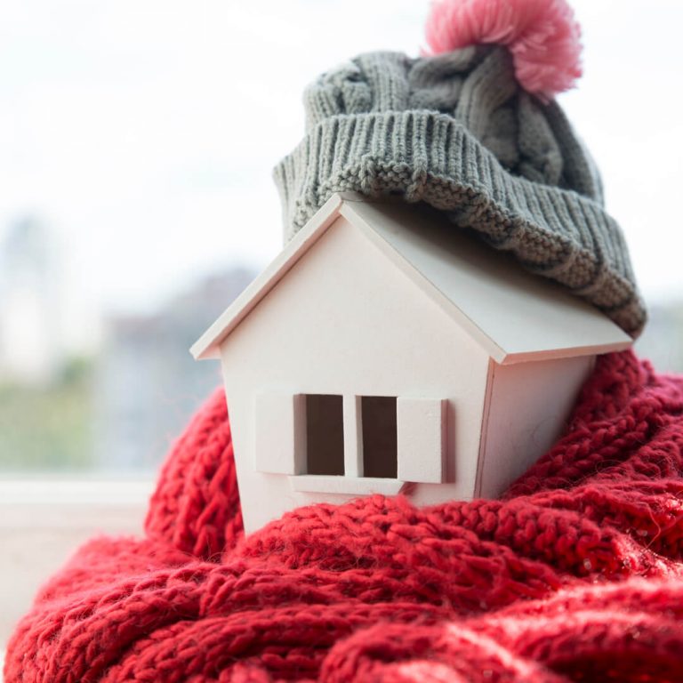 Model house wrapped in scarf and hat.