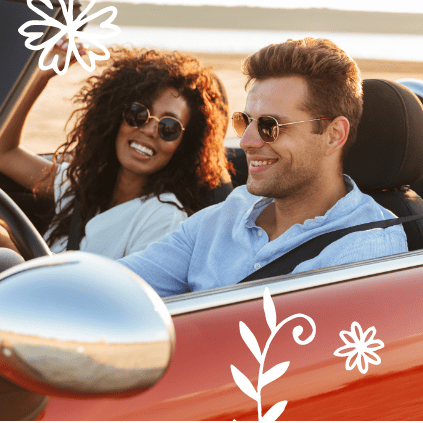 A young couple drives in their convertible covered by Quorum's auto insurance.