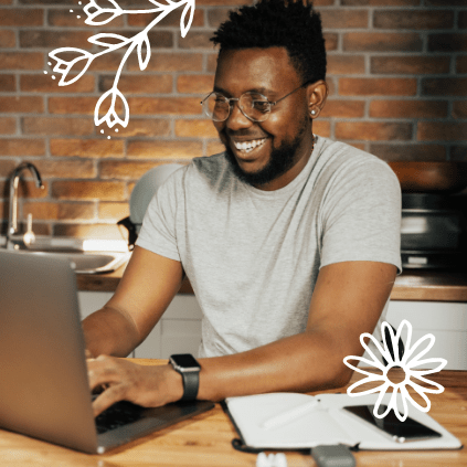 A young man uses his laptop to make a balance transfer to his Quorum credit card.