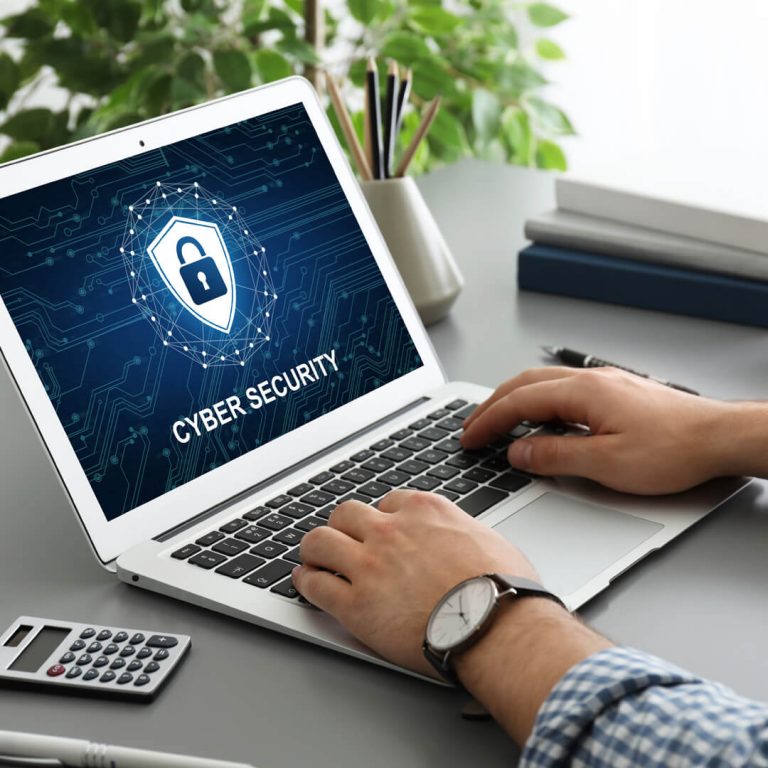 Closeup of computer screen and keyboard, with "Cybersecurity" written on monitor.