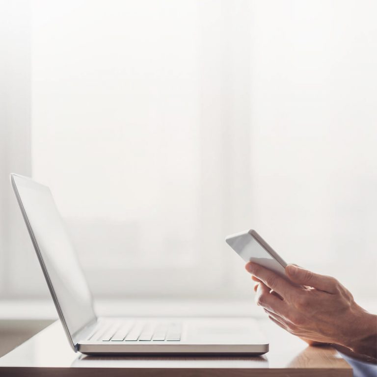 Closeup of laptop and mobile device.