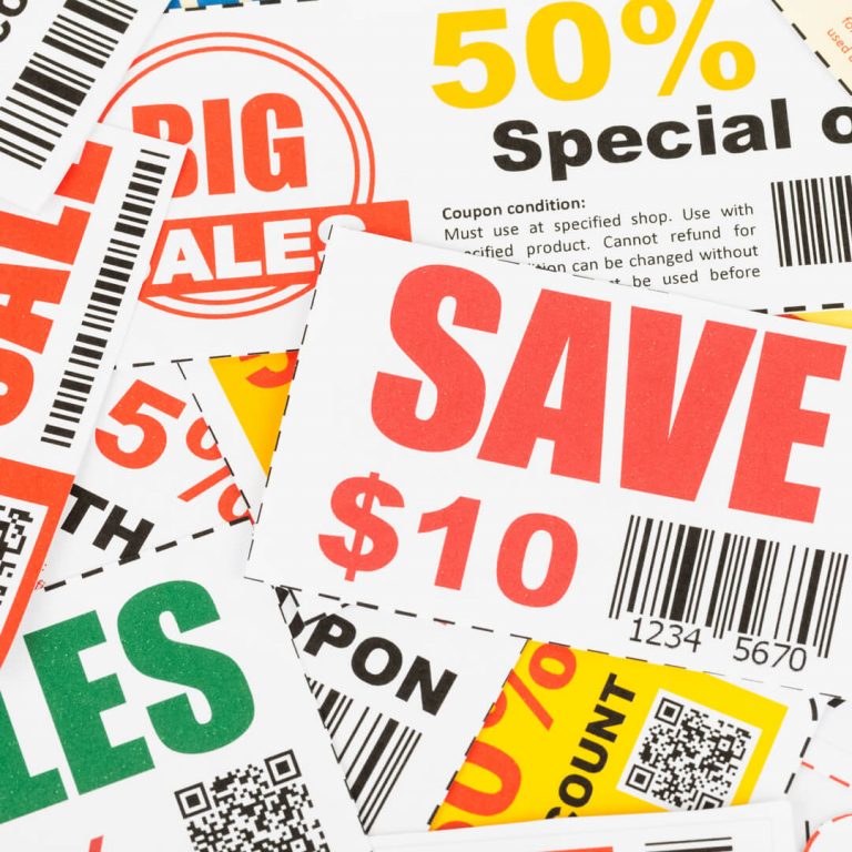 Numerous coupons on table.
