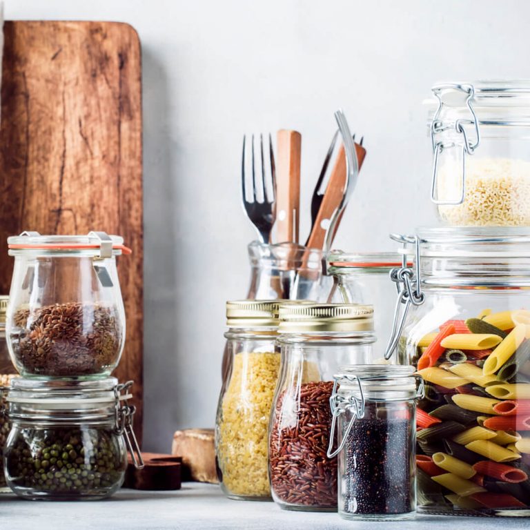 Various pantry items in glass jars, like dried pasta and lentils.
