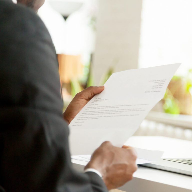Closeup of recruiter reading a cover letter from a job candidate.