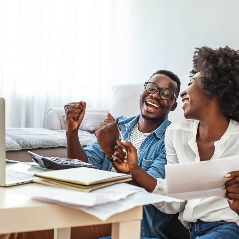Young Couple smiling, working on budget and saving money.