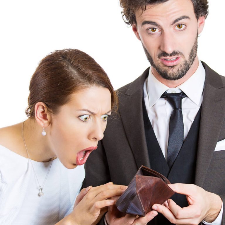 Couple who quit their jobs staring in horror at an empty wallet.