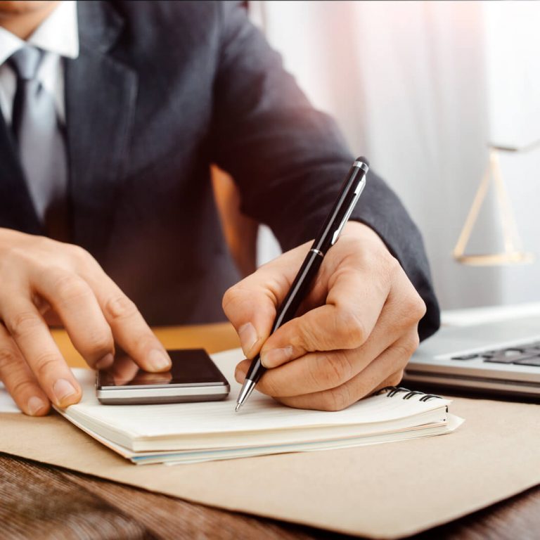 Closeup of businessman drafting legal insurance.