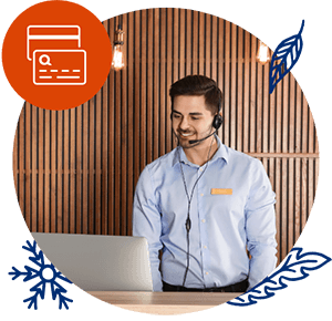 A handsome man wearing a headset and standing in front of a computer.