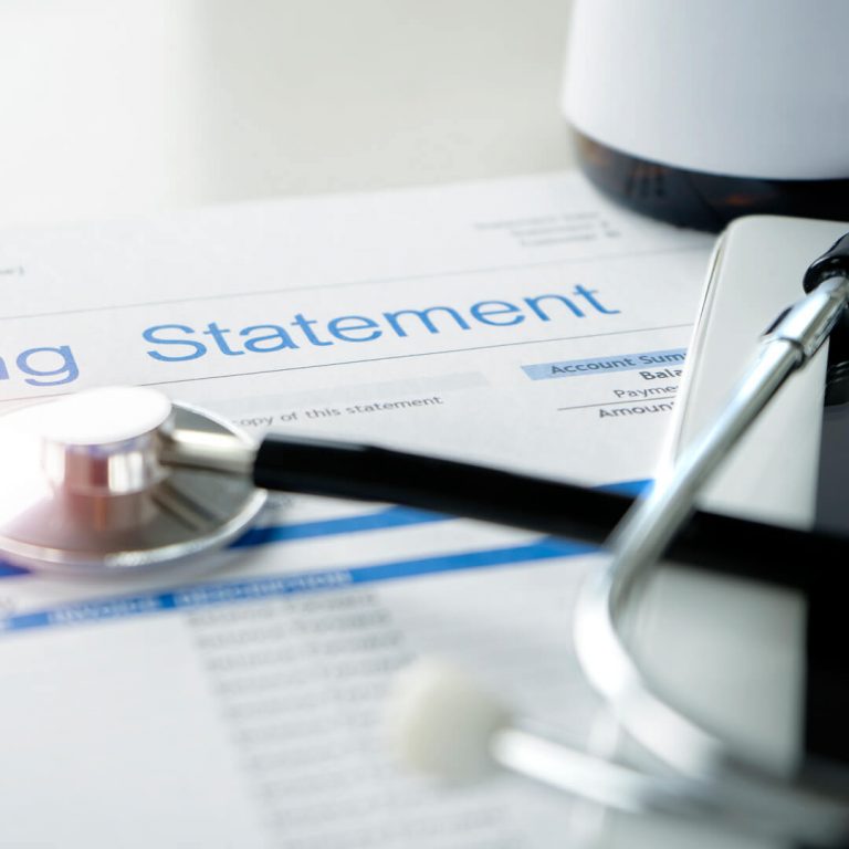 Medical bill statement with stethoscope over it.