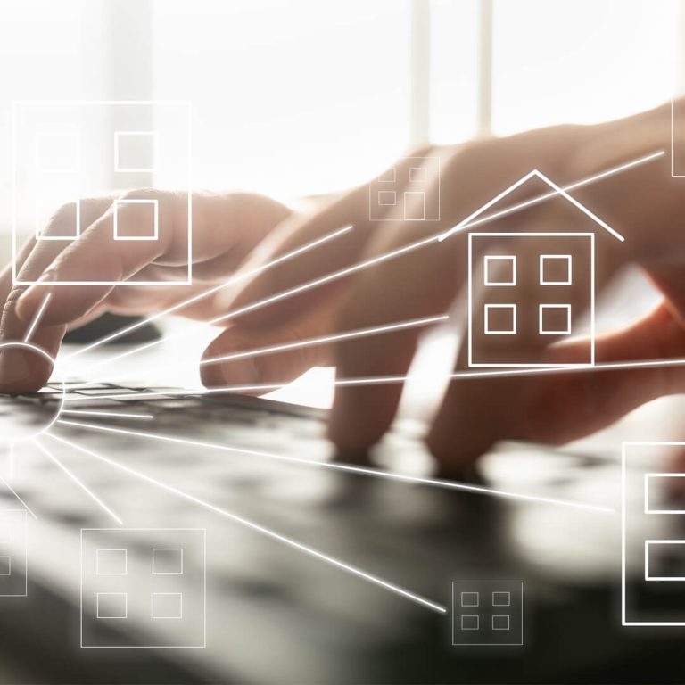 Hands on keyboard with graphic of home superimposed; concept of looking for a home.