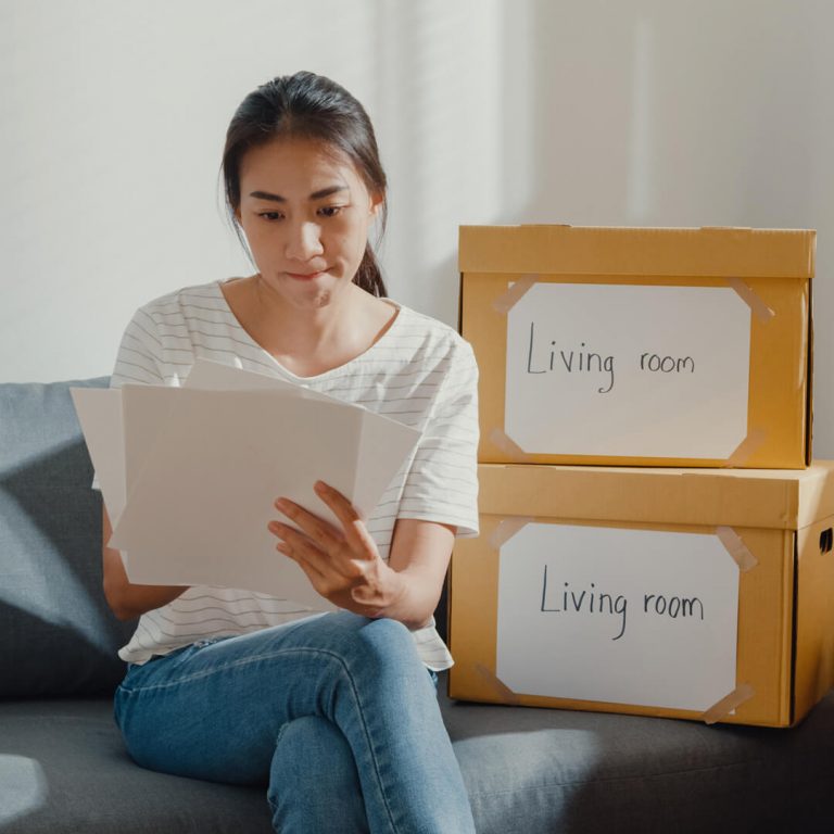 Woman looks at checklist while planning for her long-distance move.