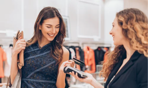 Young woman shops for luxury items using her QPlus Checking Account & Mastercard Debit Card