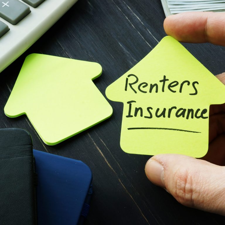 Renters Insurance written on notepad next to calculator