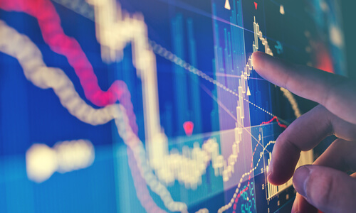 Closeup of financial screen showing a volatile market trend graph.