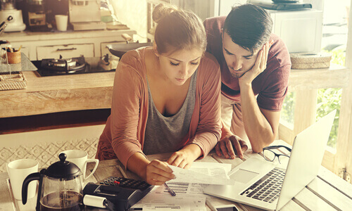 Serious couple going over their finances and debt consolidation options.