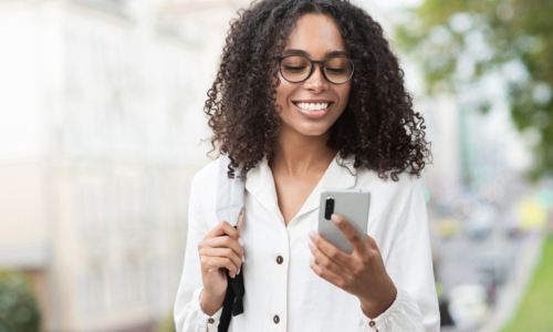 Woman outside looking at phone