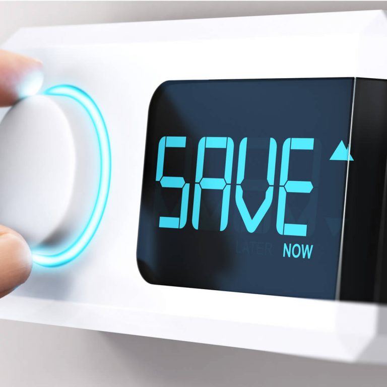 Closeup of hand on thermostat, with the letters SAVE displayed.