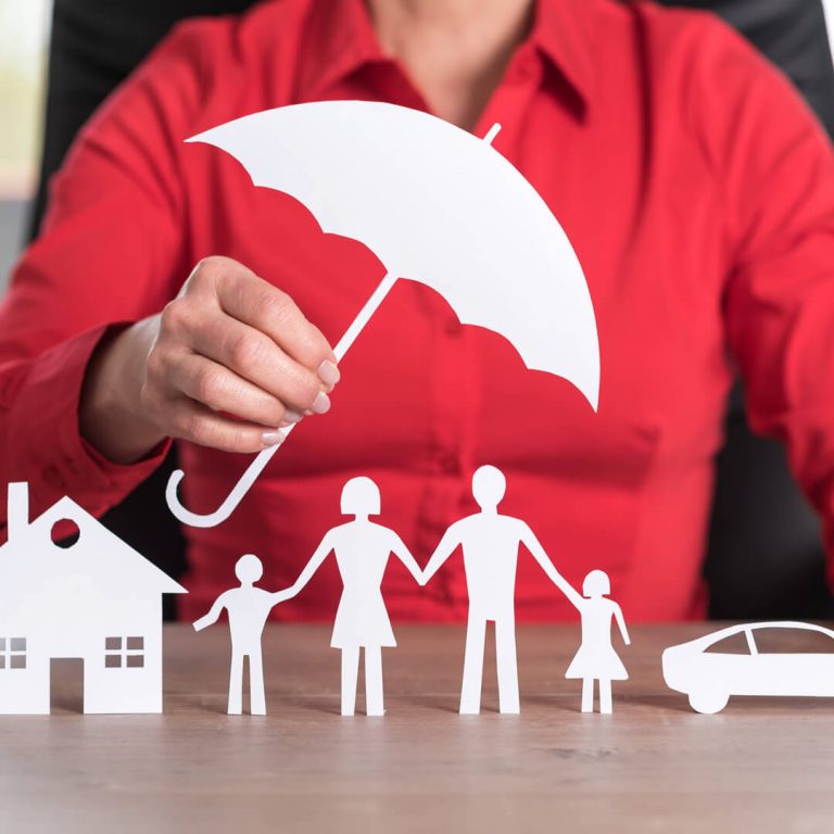 Umbrella Insurance - paper cutouts of umbrella shielding a home, family, and car.