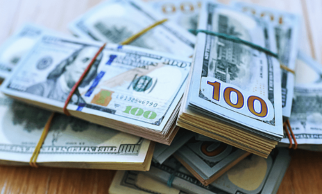 Stack of money on table.