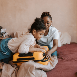 Child And Mother Packing Bags