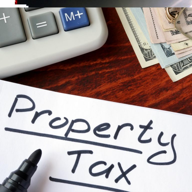 "Property tax" written in a notebook and calculator.