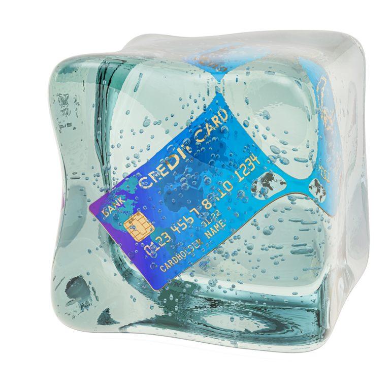 Credit card in ice cube, credit freeze concept.