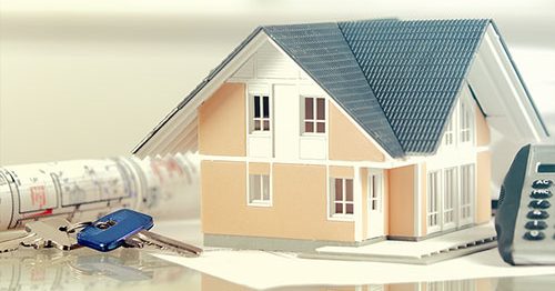 Concept of HELOC vs home equity loan: house, keys, calculators on table.