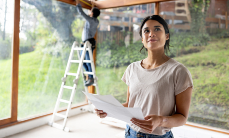 Woman looking at blueprints for home renovation