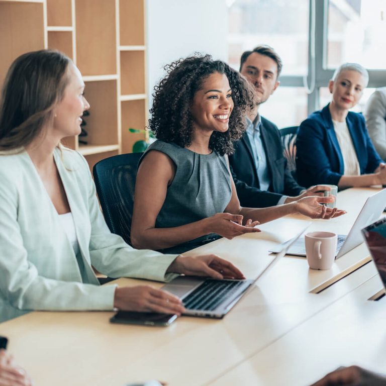 Smiling careerwoman leading business meeting in conference room.