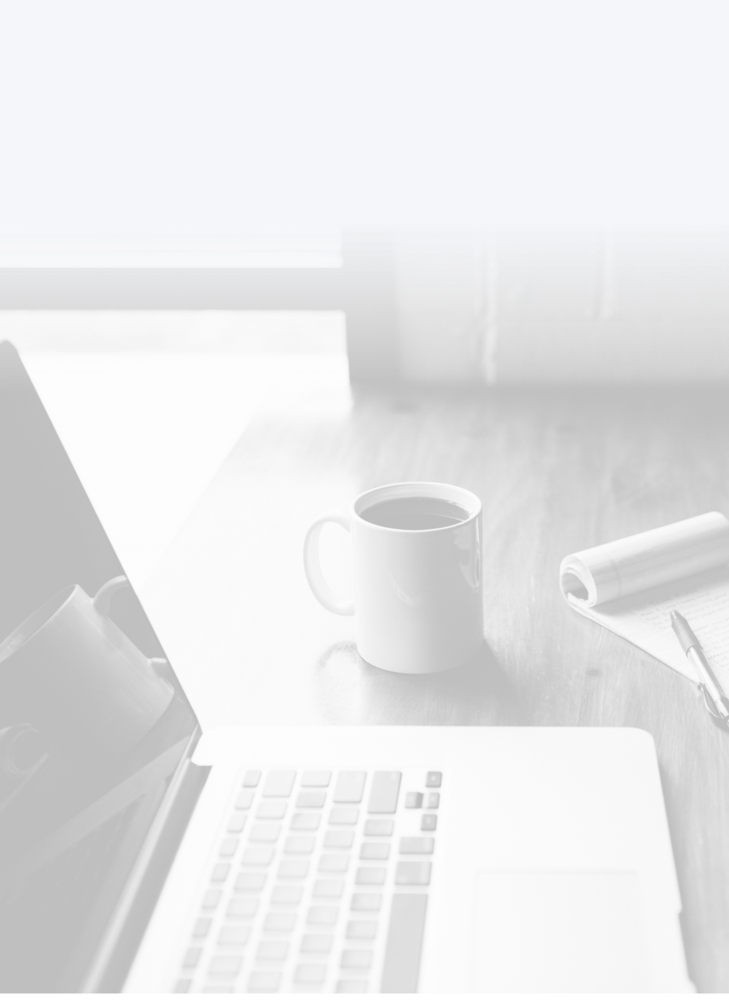 desk with laptop and cup of coffee