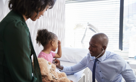 Little girl seeing doctor at a medical visit.