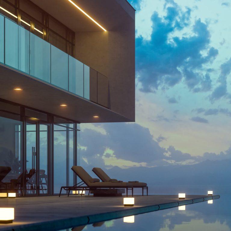 Luxury Real Estate Investment Property with infinity pool at sunset.