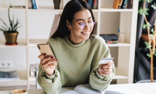 Woman on couch at home shopping online