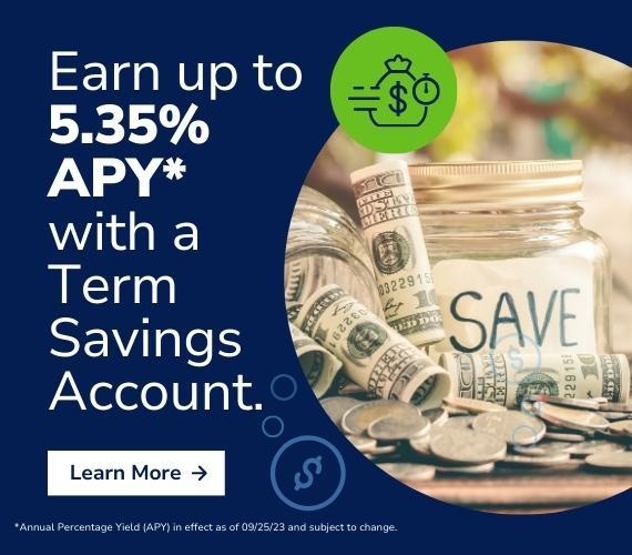 Rolls of cash, coins, and a savings jar sit on a wooden table to show how much money someone can earn with Q's Term Accounts.