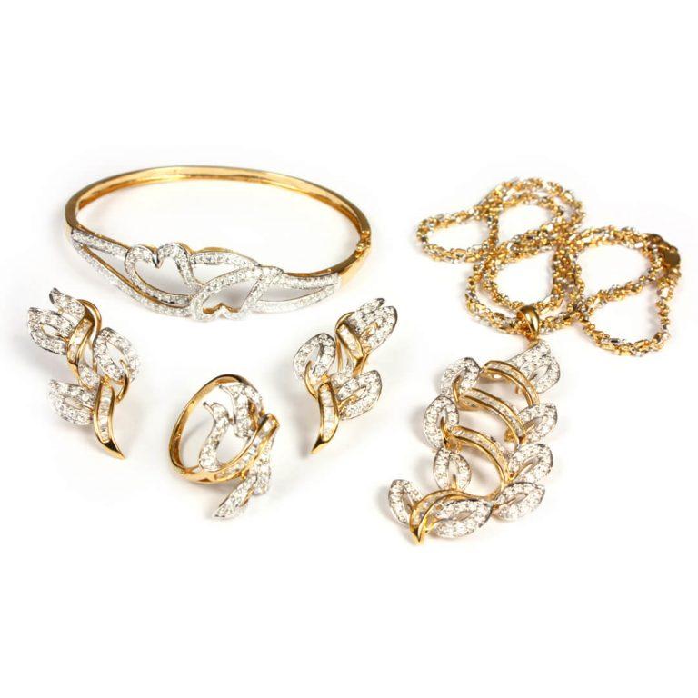 Gold and diamond jewelry on white background: a "buy" in late February.